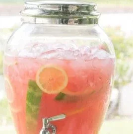 Refreshing watermelon lemonade served in a glass with ice and lemon slices