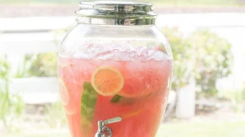 Refreshing watermelon lemonade served in a glass with ice and lemon slices