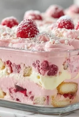 Delicious White Chocolate Raspberry Tiramisu dessert served on a white plate.