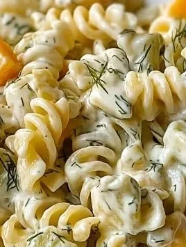 Colorful dill pickle pasta salad in a bowl, perfect for summer picnics.