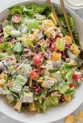 A vibrant and fresh BLT Salad with bacon, lettuce, and tomatoes.