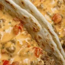 Cheesy Rotel beef soft tortilla tacos topped with fresh ingredients