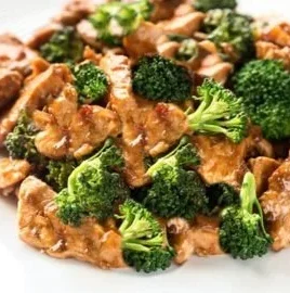 Delicious Chinese chicken and broccoli served on a plate with steam rising