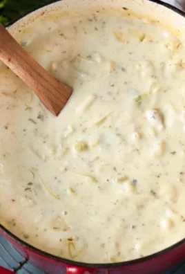 Delicious creamy New England clam chowder served in a bowl with clams and herbs