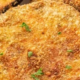 Crispy air fryer eggplants served in a bowl, garnished with herbs.