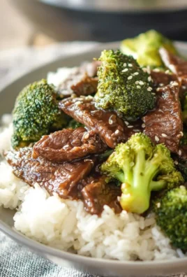 Crockpot Beef and Broccoli dish served in a bowl with rice.