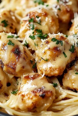 Garlic Butter Chicken Bites served with creamy parmesan pasta on a plate
