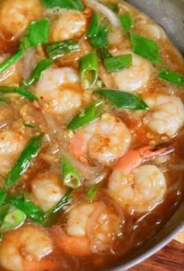 Garlic shrimp rice bowl with fresh vegetables and aromatic herbs