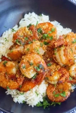 Plate of Hawaiian Garlic Shrimp garnished with fresh herbs