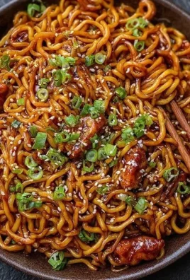 Bowl of Korean spicy chicken noodles with vibrant vegetables and seasoning