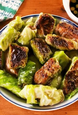 Low-carb cabbage dumplings served on a plate with garnishes.