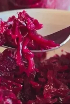 Bowl of naturally fermented red cabbage sauerkraut with vibrant purple color.