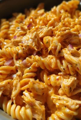 One-Pot BBQ Ranch Chicken Pasta prepared in a skillet, garnished with herbs.