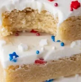 Patriotic sugar cookie bars decorated for holidays with red, white, and blue frosting.