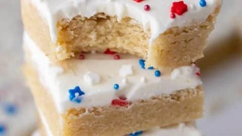 Patriotic sugar cookie bars decorated for holidays with red, white, and blue frosting.