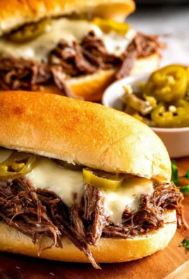 Delicious Slow Cooker Mississippi Pot Roast Sandwiches served with toppings.