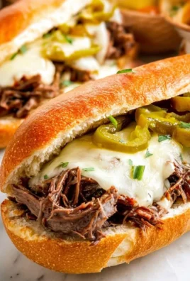 Slow Cooker Mississippi Pot Roast Sandwiches served with pickles and sauce