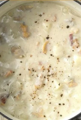 Bowl of traditional New England clam chowder with clams and herbs