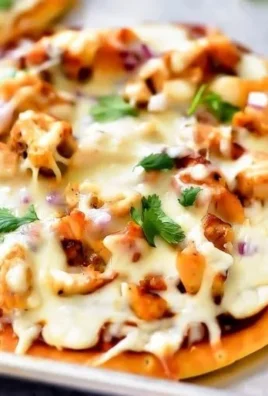 Delicious barbecue chicken flatbread pizza topped with cheese and fresh herbs