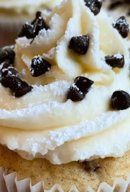 Delicious Cannoli Cupcakes topped with creamy ricotta filling and chocolate chips