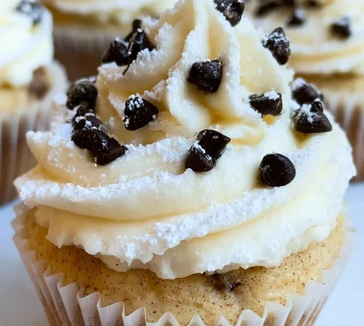 Delicious Cannoli Cupcakes topped with creamy ricotta filling and chocolate chips