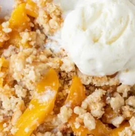 Delicious easy peach crumble dessert with golden crumble topping and fresh peaches.