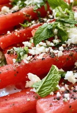 Epic watermelon fries topped with feta cheese and garnished for summer snack