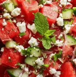 Fresh watermelon salad with feta cheese and mint leaves on a plate