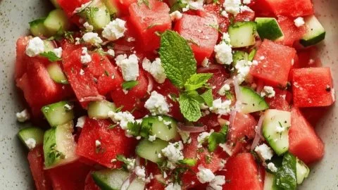 Fresh watermelon salad with feta cheese and mint leaves on a plate