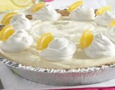Delicious frozen lemonade pie topped with lemon slices and whipped cream