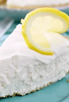 Delicious Frozen Lemonade Pie topped with fresh lemon slices and mint
