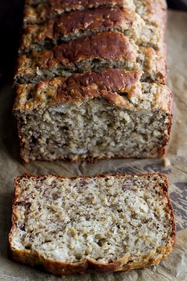 Delicious Greek yogurt banana oat bread slice on a wooden table.