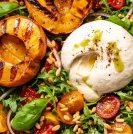 Grilled peach burrata salad with fresh greens and balsamic glaze