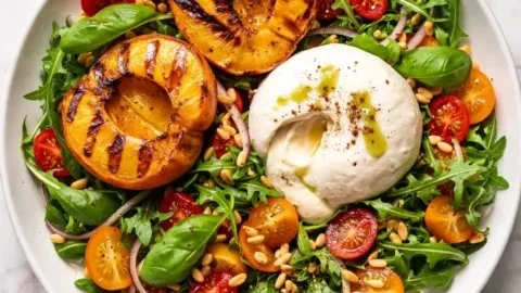 Grilled peach burrata salad with fresh greens and balsamic glaze