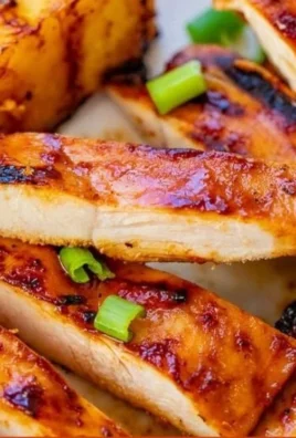 Hawaiian grilled chicken served with pineapple slices on a plate