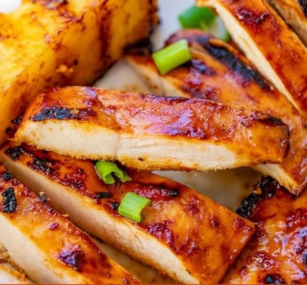 Hawaiian grilled chicken served with pineapple slices on a plate