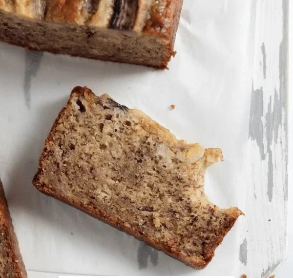 Slices of healthy gluten-free banana bread on a wooden cutting board