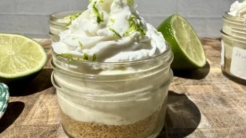 High Protein Key Lime Cups dessert with lime zest and whipped topping