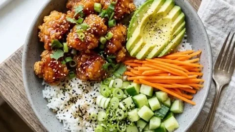 Delicious hot honey chicken bowls topped with fresh ingredients and drizzled with honey