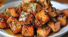 Delicious hot honey salmon bites garnished and ready to serve as an appetizer