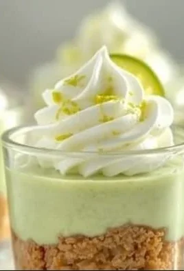Delicious Key Lime Cheesecake Cups topped with whipped cream and lime zest