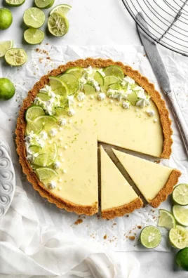 Delicious slice of homemade Key Lime Pie with zest and cream topping.