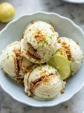 Delicious key lime pie ice cream served in a bowl with lime slices.