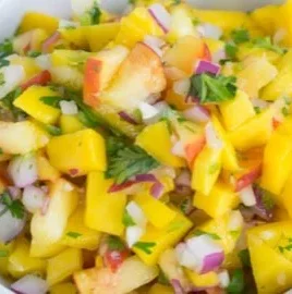 A bowl of colorful Mango Peach Salsa with fresh ingredients