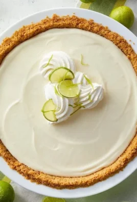 Delicious no-bake key lime pie topped with whipped cream and lime zest