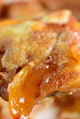 Delicious homemade Peach Cobbler with golden crust and juicy peaches