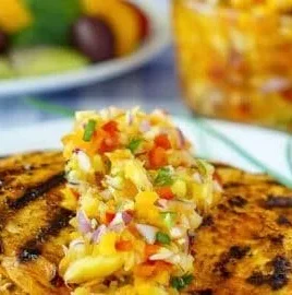 Pineapple salsa served over lemon paprika grilled chicken