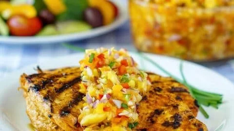 Pineapple salsa served over lemon paprika grilled chicken
