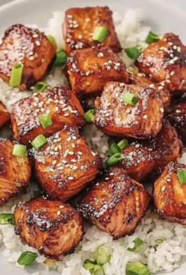 Honey garlic salmon bites served on a plate with garnishing