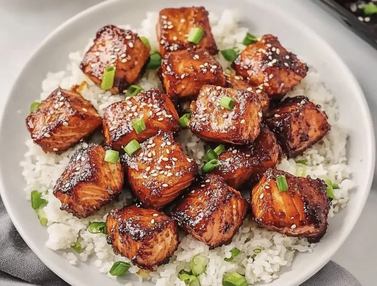Honey garlic salmon bites served on a plate with garnishing